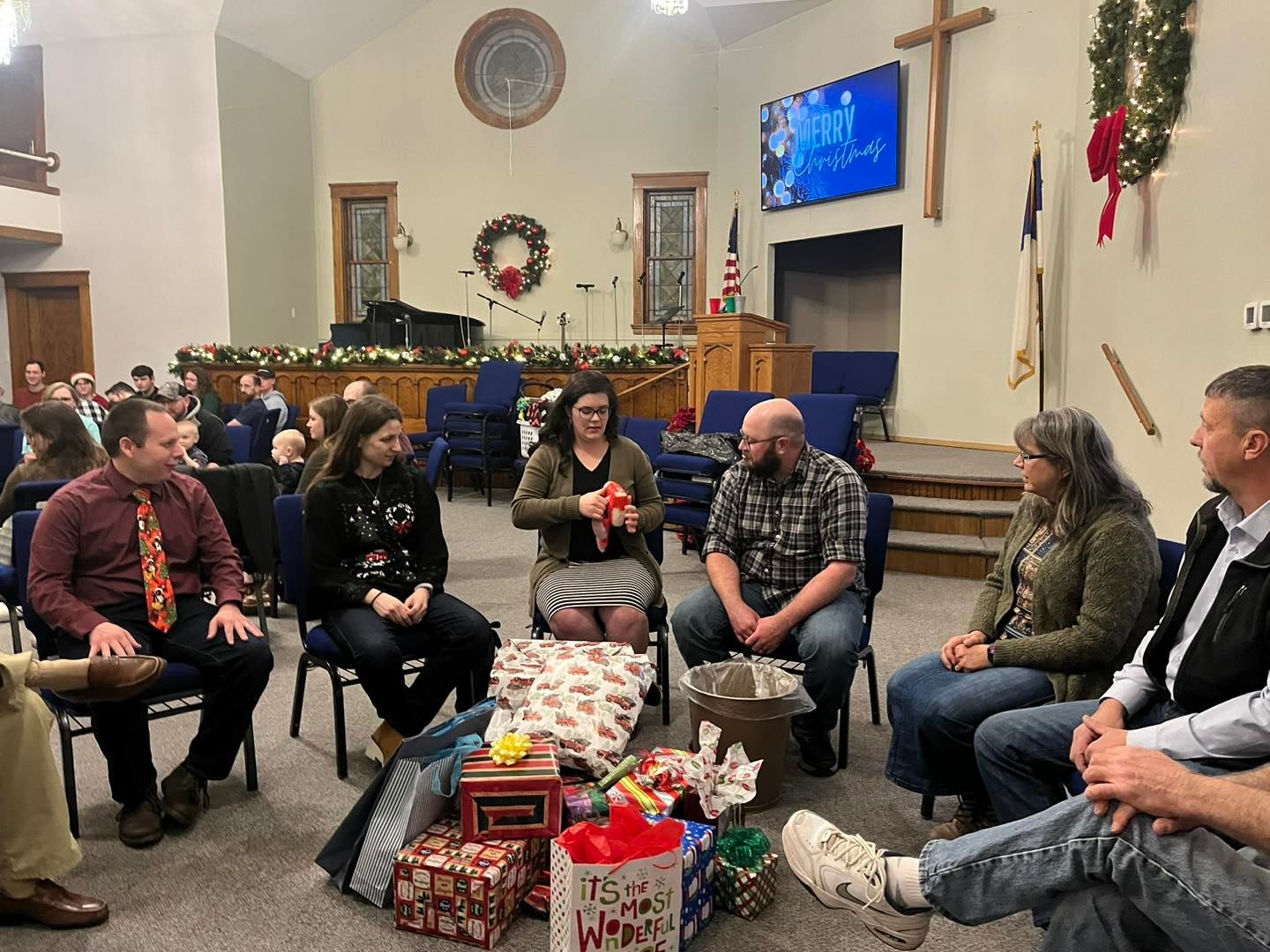 Plains Baptist Church Christmas party, young married couples opening gifts, white elephant gift exchange, games